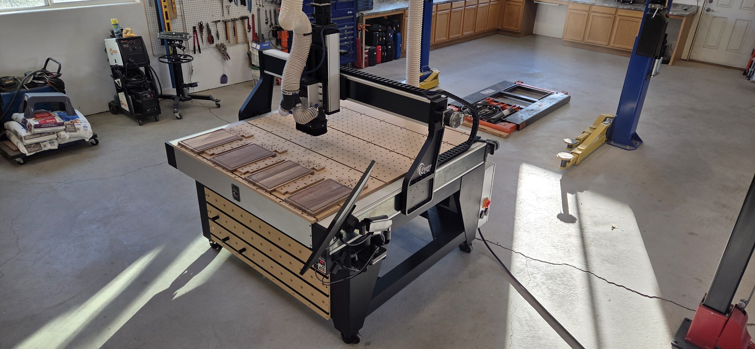 Wide-angle view of the Fusion Pro CNC 50x50 deployed in a real shop environment